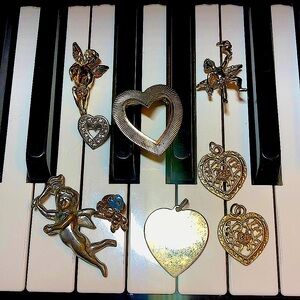 Collection of vintage heart and Cupid brooches and pendants